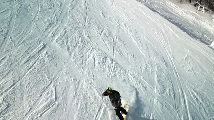 top down aerial footage of a snowboarder carving down Yabuli resort