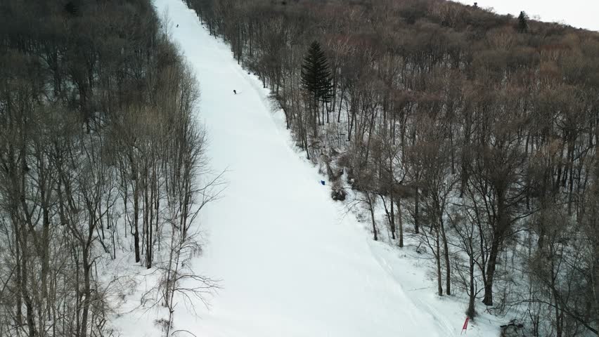 The aerial footage features a snowboarder carving down Yabuli resort