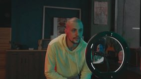 Influencer On Social Media. Cheerful Young Man Dancing In Front Of Camera. He Looks At Phone And Touches His Face. - Powered by Shutterstock - Get 15% off with code: PIKWIZARD15