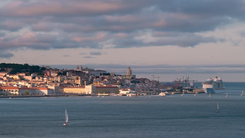 Time-lapse of Lisbon view over Tagus river from Almada with yachts and ferry boats on sunset. Lisbon, Portugal. Zoom out effect Royalty-Free Stock Footage #1102805971