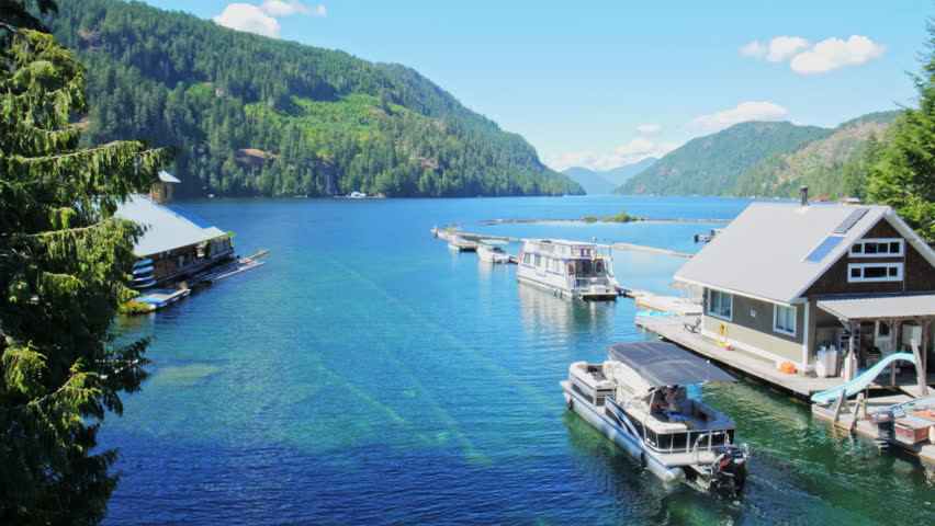 Pleasure Boat Navigating Next to Marina Quay on Beautiful Summer Day in Port Alberni Region, British Columbia Canada