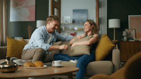 Laughing couple having fun at home. Cheerful spouses relaxing couch at modern room. Happy smiling wife husband sharing jokes talking together at house. Cute pair feeling carefree enjoying romantic day - Powered by Shutterstock - Get 15% off with code: PIKWIZARD15