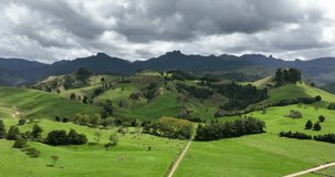 Farm aerial view surrounded by mountains. New Zealand, North Island