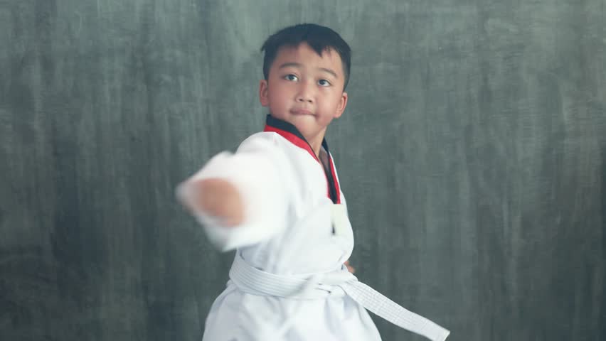 Asian boy practicing taekwondo, a martial art, karate martial arts Royalty-Free Stock Footage #1102820249