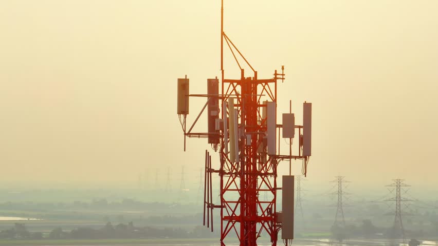 The antennas on a cell site tower transmit and receive data to and from mobile devices using various wireless communication protocols such as 4G LTE, 5G, or Wi-Fi. Technology and industry concept
 Royalty-Free Stock Footage #1102820851