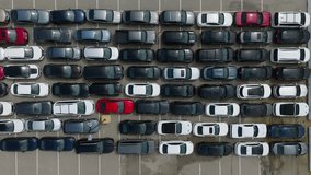 Aerial top view from drone of parking lot cars. Aerial view of the parked new cars. Drone flies over a large used car parking lot. Logistics transit. Car dealer parking lot full of new automobiles.  - Powered by Shutterstock - Get 15% off with code: PIKWIZARD15