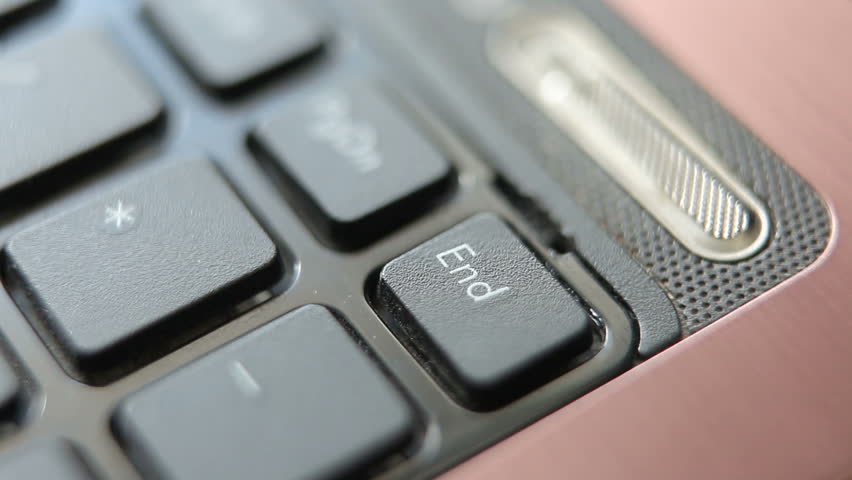 A man or woman presses the End key on a laptop. macro photography. Royalty-Free Stock Footage #1102824419