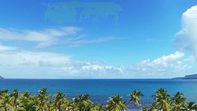 Paradise beach with palm trees in Bali. Tropical coast. Calm sea. Coconut palms on the background of the blue ocean. Sea beach vacation. Bright blue cloudy sky. Walk along the ocean.