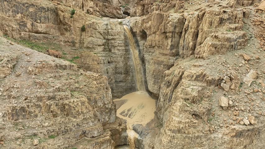 waterfall in the desert ,flash flood muddy water, Aerial view ,Dead Sea ,Israel. Royalty-Free Stock Footage #1102830365
