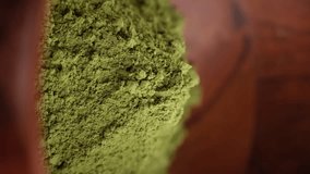 Heap of Matcha green tea powder in wooden bowl. Healthy drinks concept. Vertical video