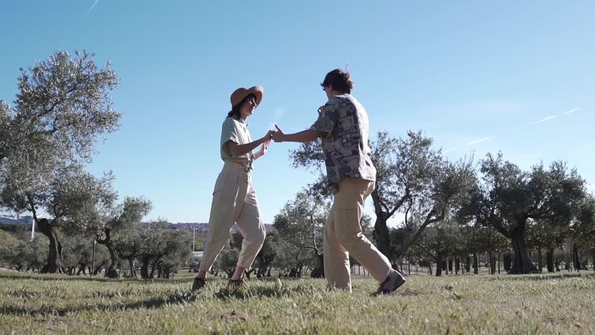 Wide shot slow motion couple women lgbt lesbians dancing together in a park nature Royalty-Free Stock Footage #1102833839