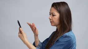 Angry woman talking with smartphone. Portrait of woman on video chat conversation