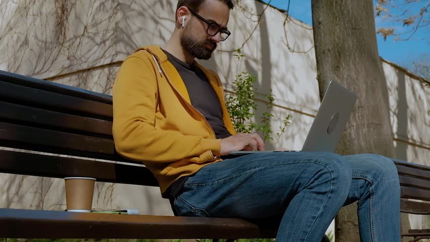Men Doing Remote Work On The Street With His Laptop