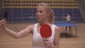 table tennis. blonde woman makes selfie on smartphone. slow motion video. High quality Full HD video recording