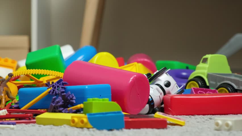 An abundance of toys in the children's room, a lot of plastic multi-colored parts from designers, spare parts for toys, figurines and cubes. Royalty-Free Stock Footage #1102844209