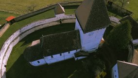 Aerial view of the fortified church in Hosman village, Romania. Video was shot from a drone while flying upwards from above the fortification with camera downwards and slowly tilting upwards.