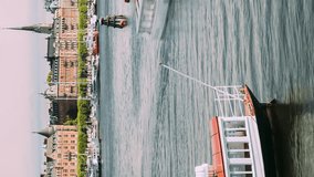 Stockholm, Sweden. Vertical Footage Video Touristic Pleasure Boats Floating In Sunny Summer Day. Concept of Travel to Sweden. City Hyperlapse. Natural Bright Sky Background. Bold Colors.