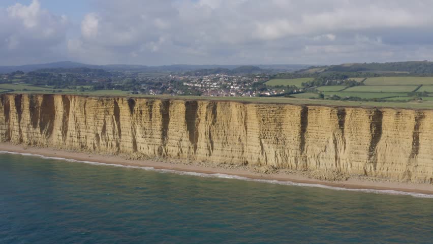 Tall Sandstone Cliffs of West Bay Along the Jurassic Coast of Southern England Royalty-Free Stock Footage #1102855731