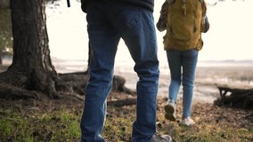 Group of tourists go hiking in nature in forest. Tall trees and water flowing through forest. Hiking in park in summer. Family rest picnic in forest. Happy family walks in forest. Active lifestyle - Powered by Shutterstock - Get 15% off with code: PIKWIZARD15