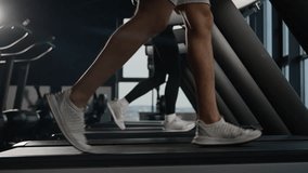 Close-up feet running on treadmill in fitness gym athletic people runners woman and man training cardio workout jogging side view of sneakers sportsman and sportswoman muscular legs run in sport club - Powered by Shutterstock - Get 15% off with code: PIKWIZARD15