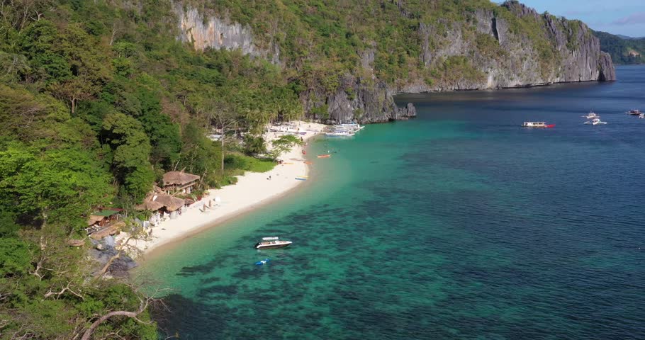 Drone video of the paradisiacal Seven Commandos beach near El Nido on the Philippine island of Palawan during the day Royalty-Free Stock Footage #1102862153
