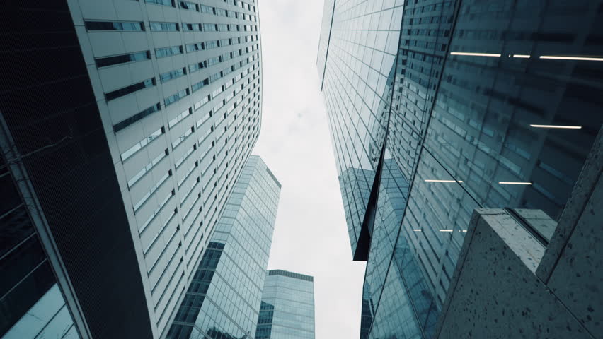 Looking up city downtown skyscrapers, modern high-rise office buildings in financial district. Business center architecture, wide angle dolly shot, glass skyscraper view from below, cinematic gimbal