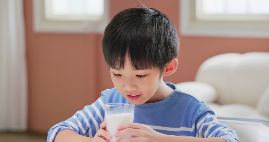 slow motion of asian children grow up happliy with parent love and healthy food - the boy is drinking milk which makes him growing up well and cheerful Royalty-Free Stock Footage #1102866619