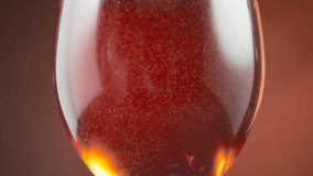 Small air bubbles floating in the rose wine in a wineglass. Slow motion. - Powered by Shutterstock - Get 15% off with code: PIKWIZARD15