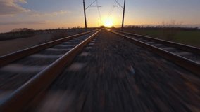Railway railroad aerial drone shot, FPV shot with hyperlapse like movement, flying towards a sunset horizon with fast speed on the tracks. - Powered by Shutterstock - Get 15% off with code: PIKWIZARD15