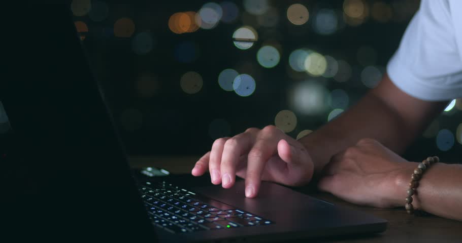 Close up of male hand using track pad on hi tech laptop computer at night time. Closeup business man using laptop touchpad - pinch, swipe and scroll, sitting outdoors at night city Royalty-Free Stock Footage #1102874197