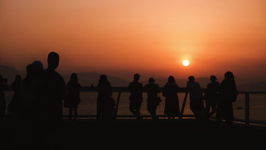 Crowd of people lifestyle silhouette on nature sunset.