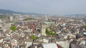 Inscription on video. Zurich, Switzerland. Panorama of the city from the air. St. Peter Church. Different colors letters appears behind small squares, Aerial View, Point of interest