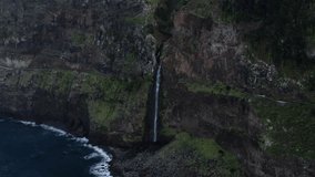 Drone footage provides stunning panoramic views of the waterfall on the Madeira cliff from Miradouro do Véu da Noiva