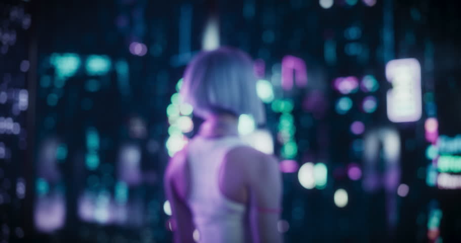 Creative Young Female in a Sci-Fi Cyberpunk City with Neon Lights, Dystopian Colorful Urban Environment. Cosplay Model with Blue Hair Excited with Technological Surroundings. Desaturated Color Edit Royalty-Free Stock Footage #1102884937