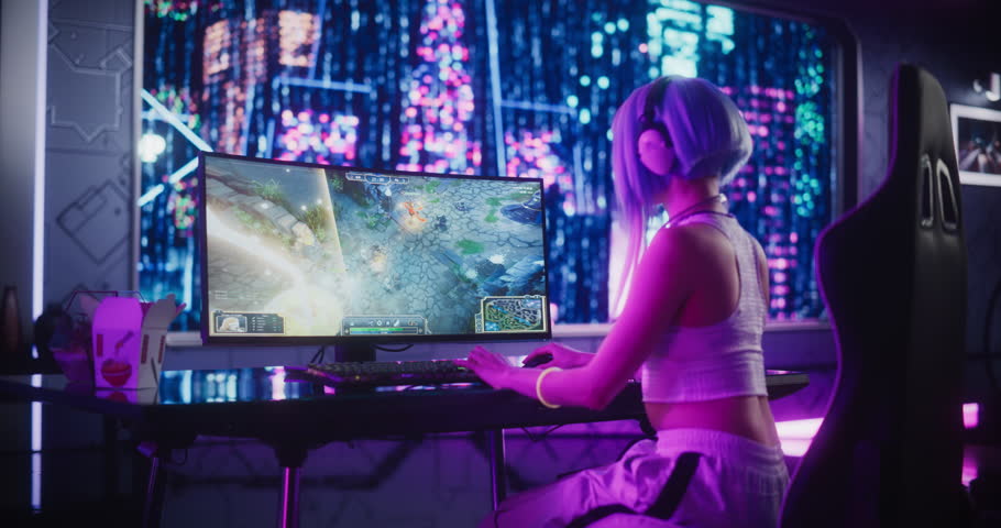 Young Woman Playing Online RPG Strategy Video Game on a Computer in a Futuristic Digital Space. Cosplay Girl with Blue Hair Streaming Entertainment Content for Internet Fans. Footage from the Back