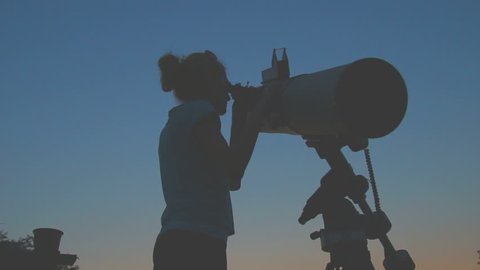 Girl stargazing with a telescope.