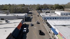 Downtown Oxford, Mississippi skyline and traffic with stable drone video.