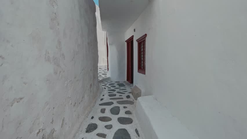 Reveal of island church in Mykonos at the end of an iconic alley Royalty-Free Stock Footage #1102903505
