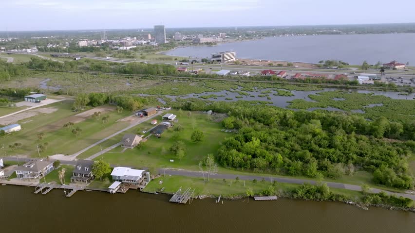 Homes along the Calcasieu River in Lake Charles, Louisiana with drone video moving left to right.