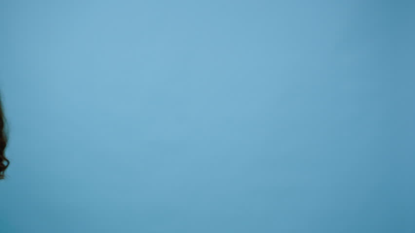 Woman walks with back forward moving hands with clenched fists in circle. Person points fingers and shows I am watching you gesture on blue background