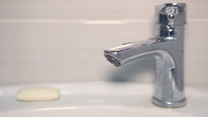 The faucet is dripping in the sink. The cartridge in the faucet leaks water. Leaking faucet. Looped video. Royalty-Free Stock Footage #1102906345