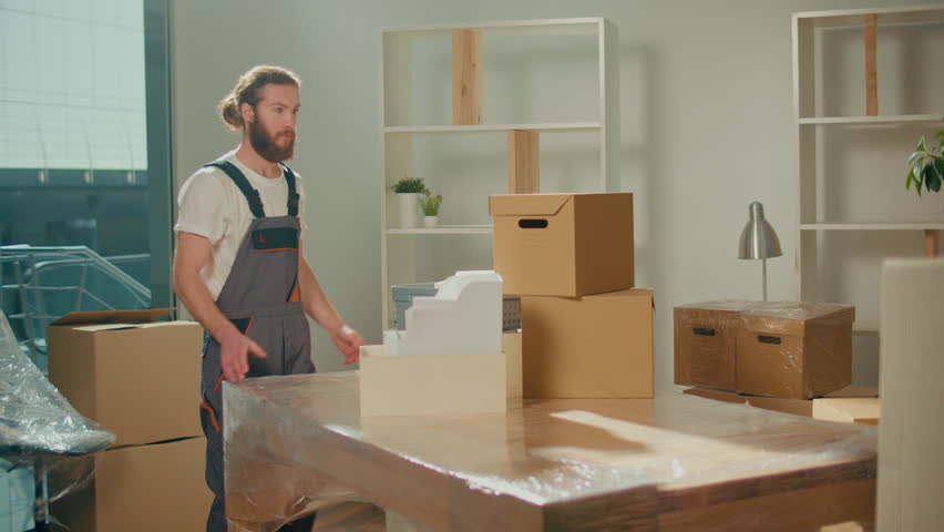 Workers of Moving Company With Uniforms Carefully Carrying Boxes. Team of Employee Workers Helps Customers to Relocation. Local Moving Services Royalty-Free Stock Footage #1102906507