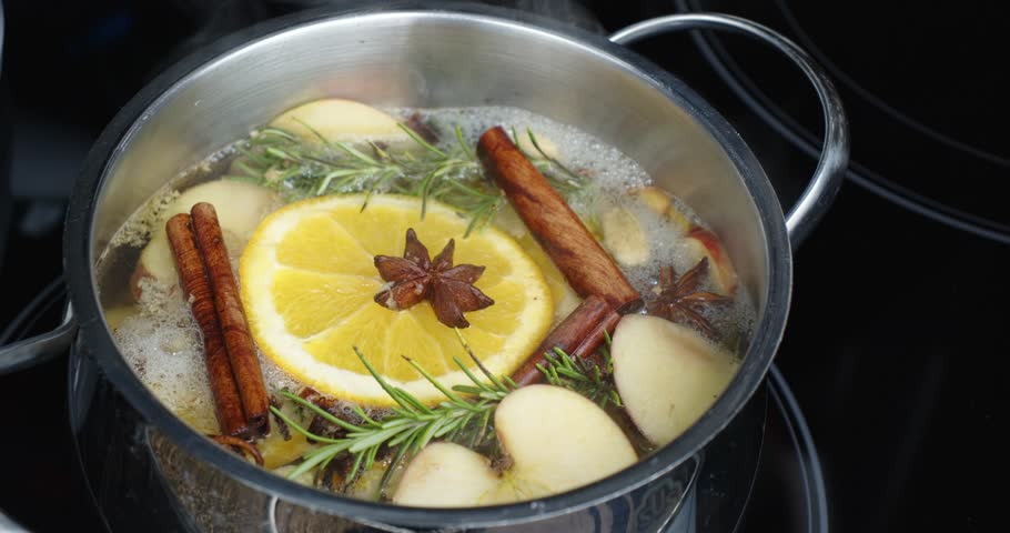 Heating homemade potpourri in a pot on the stove to give a nice fragrance to the kitchen.  Orange, Star Anise, Rosemary, Apples and Spices make a wonderful smell. Royalty-Free Stock Footage #1102909707