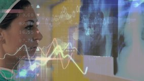 A surgeon is looking at x-rays in a hospital. Global business data processing and digital interface concept digitally generated video. - Powered by Shutterstock - Get 15% off with code: PIKWIZARD15