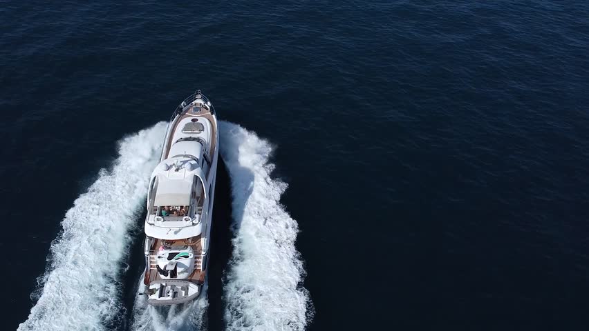 Luxury motor yacht moving on the sea in the tropics, top view of a motor yacht in motion on the sea