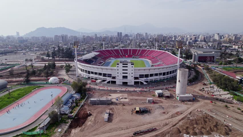 National Stadium of Chile while undergoing renovation. A drone shot during the day with polluted sky Royalty-Free Stock Footage #1102921543