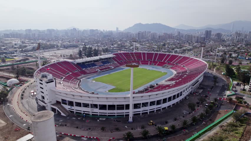 National Stadium of Chile while undergoing renovation. A drone shot during the day with polluted sky Royalty-Free Stock Footage #1102921549