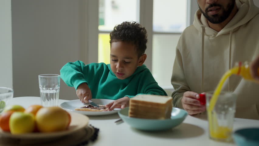 Father and son having breakfast together. | Shutterstock HD Video #1102923619