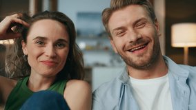 Pov smiling lovers laughing at home weekend. Emotional happy pair enjoying comedy movie sitting at evening together. Carefree excited couple watching funny show at living room interior closeup view - Powered by Shutterstock - Get 15% off with code: PIKWIZARD15