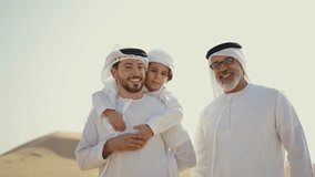Three generation family spending time in the desert making a safari in Dubai. Concept about middle eastern cultures and lifestyle in the emirates - Powered by Shutterstock - Get 15% off with code: PIKWIZARD15